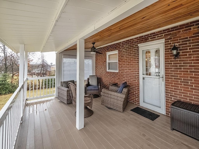 wooden deck featuring a ceiling fan, radiator, and heating unit