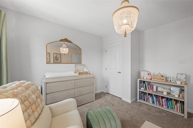 sitting room with an inviting chandelier, baseboards, and carpet flooring