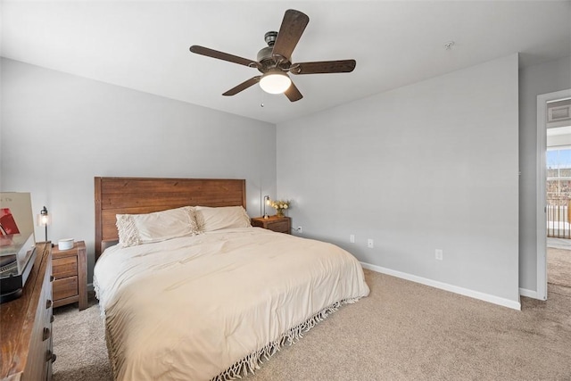 carpeted bedroom with a ceiling fan and baseboards