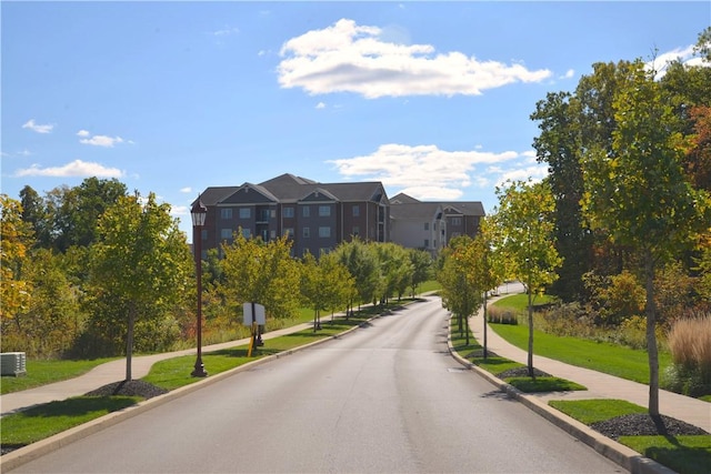 view of road with sidewalks and curbs