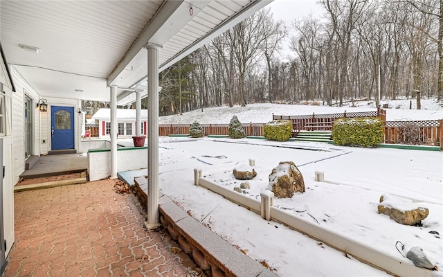 yard covered in snow featuring fence