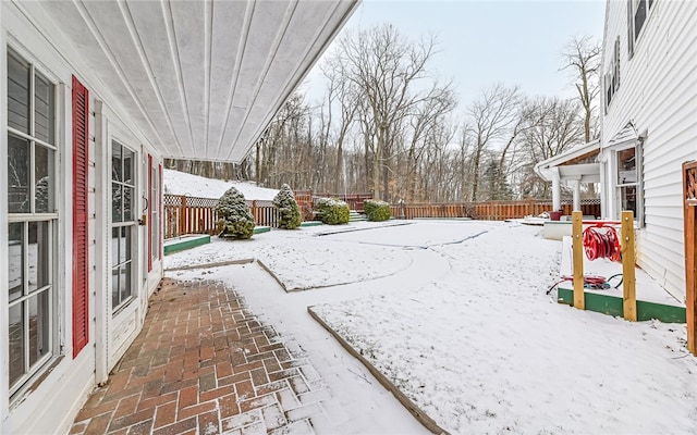 yard covered in snow featuring a fenced backyard