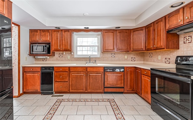 kitchen with light countertops, stainless steel microwave, electric range, a sink, and dishwasher