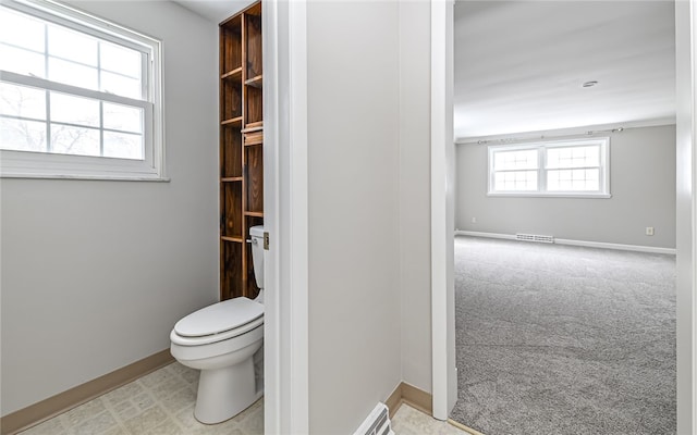 bathroom with toilet, visible vents, and baseboards