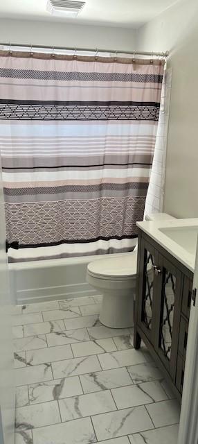 bathroom with marble finish floor, visible vents, toilet, shower / bath combo, and vanity