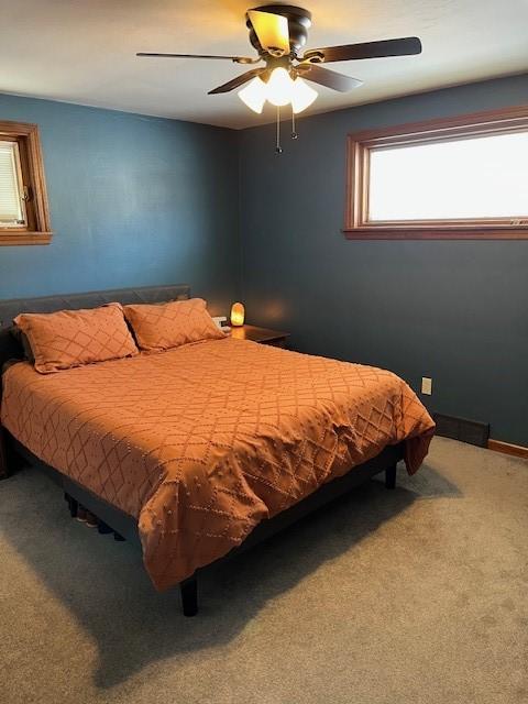 bedroom featuring a ceiling fan, carpet flooring, and baseboards