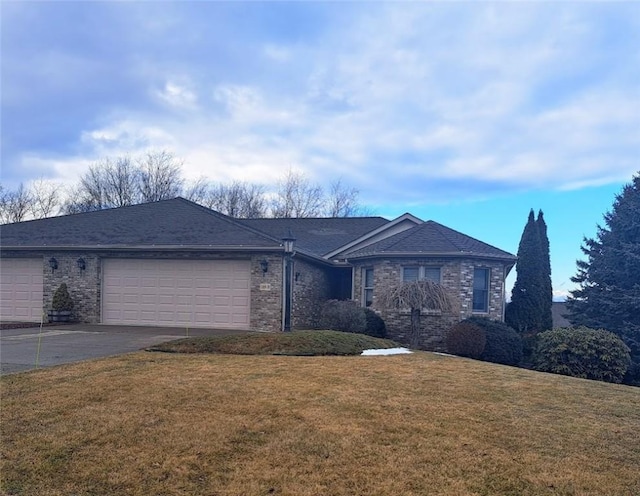 ranch-style home featuring driveway, a garage, a front lawn, and brick siding