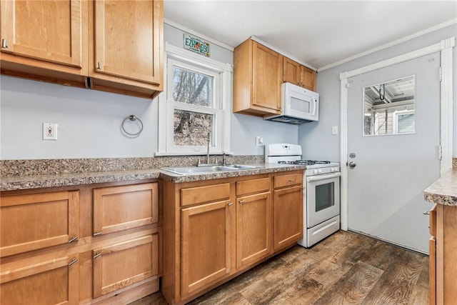 kitchen with white appliances, dark wood-style flooring, light countertops, crown molding, and a sink