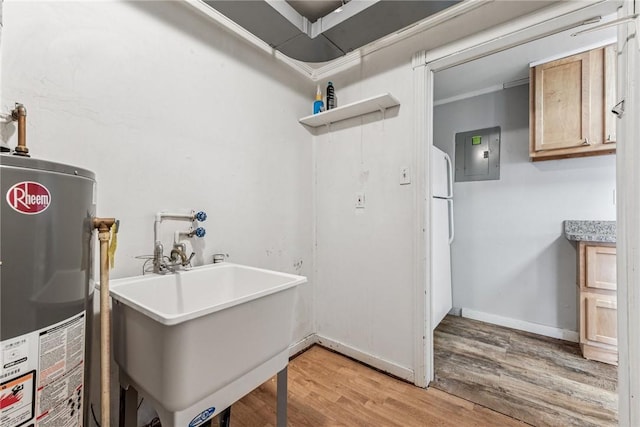 laundry room with water heater, light wood-style floors, a sink, electric panel, and baseboards