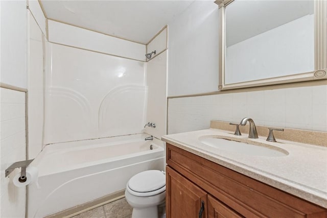 bathroom featuring a wainscoted wall, tile walls, toilet, washtub / shower combination, and vanity