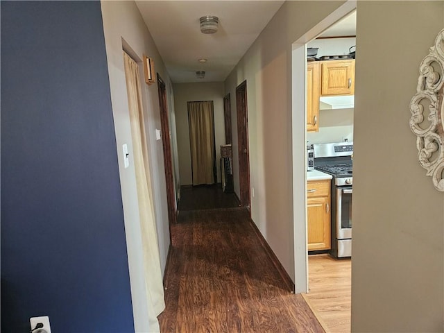 corridor featuring dark wood-style flooring