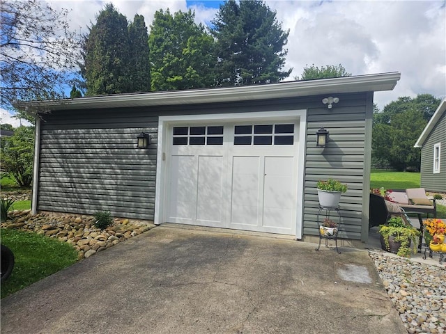 garage featuring concrete driveway