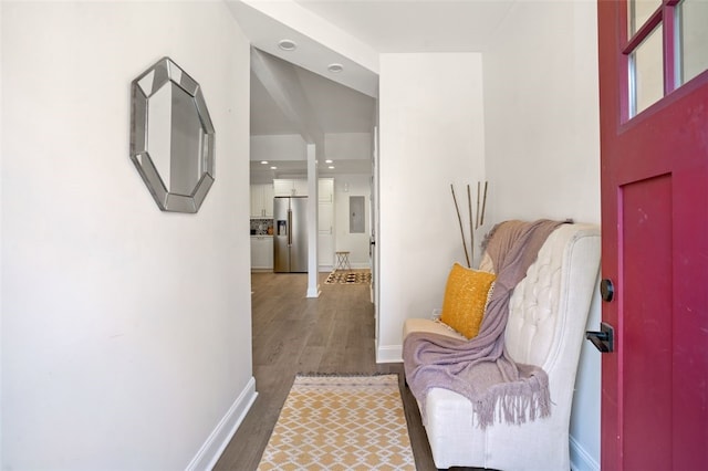 hallway featuring dark wood-type flooring and baseboards