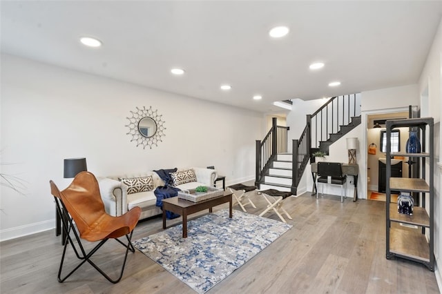 living area featuring stairs, wood finished floors, and recessed lighting