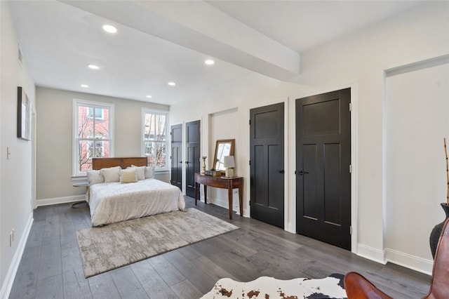 bedroom featuring recessed lighting, dark wood finished floors, baseboards, and two closets