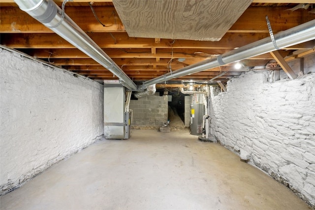 unfinished basement featuring water heater and heating unit