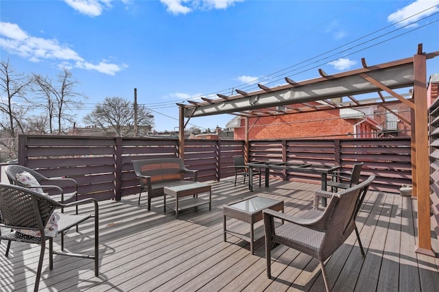 deck featuring an outdoor living space and a pergola