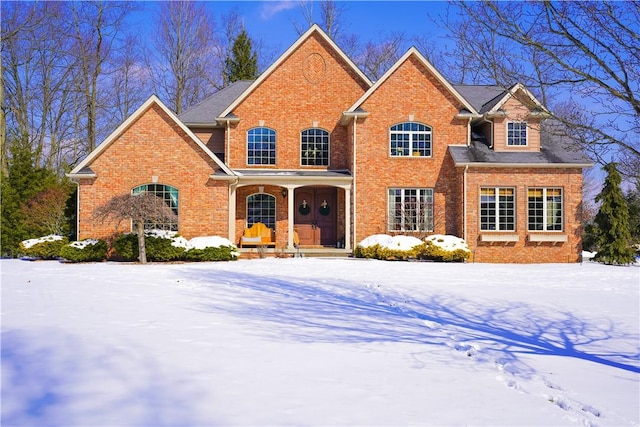 traditional-style home featuring a porch and brick siding