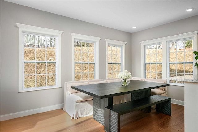 dining area with light wood-type flooring, baseboards, and recessed lighting