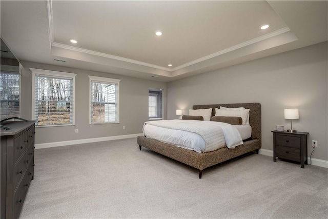 bedroom with crown molding, baseboards, a raised ceiling, and carpet flooring