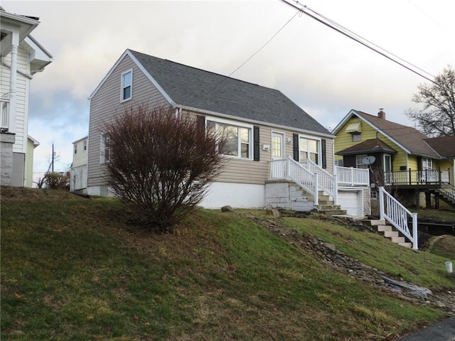 view of front of home with stairway and a front lawn