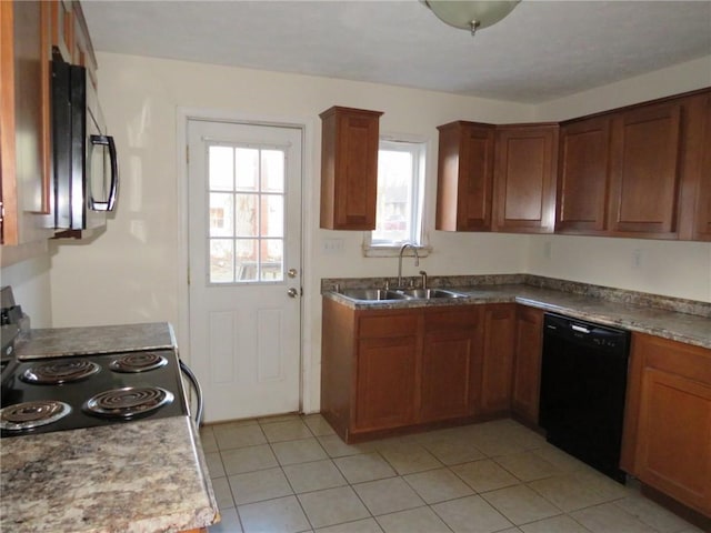 kitchen with light tile patterned floors, a sink, light countertops, brown cabinets, and black appliances