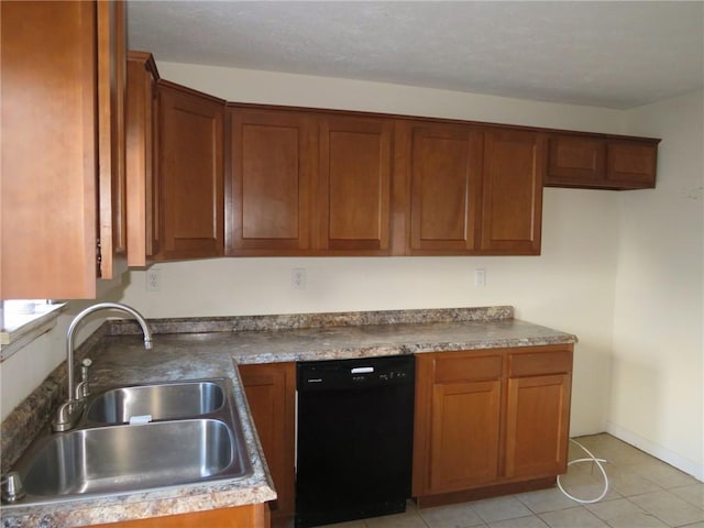 kitchen featuring black dishwasher, light tile patterned floors, a sink, and brown cabinets