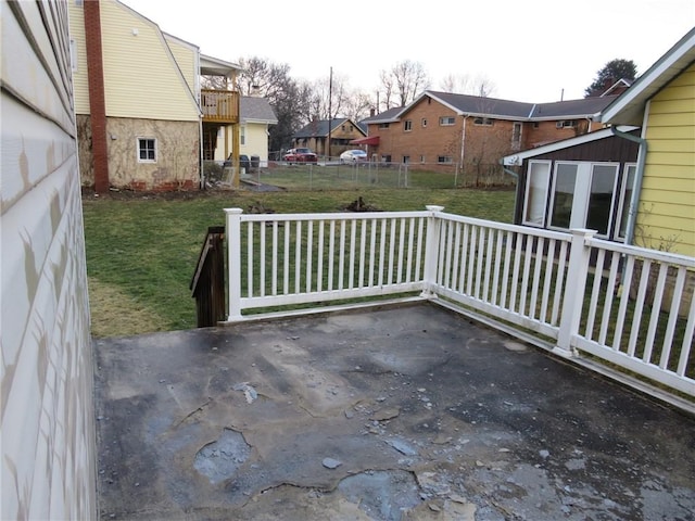 view of patio / terrace featuring a storage shed, an outdoor structure, fence, and a residential view