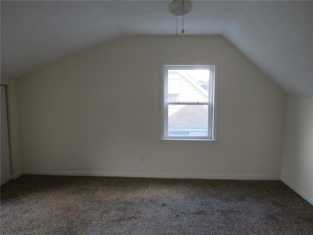 additional living space featuring lofted ceiling, carpet, and baseboards