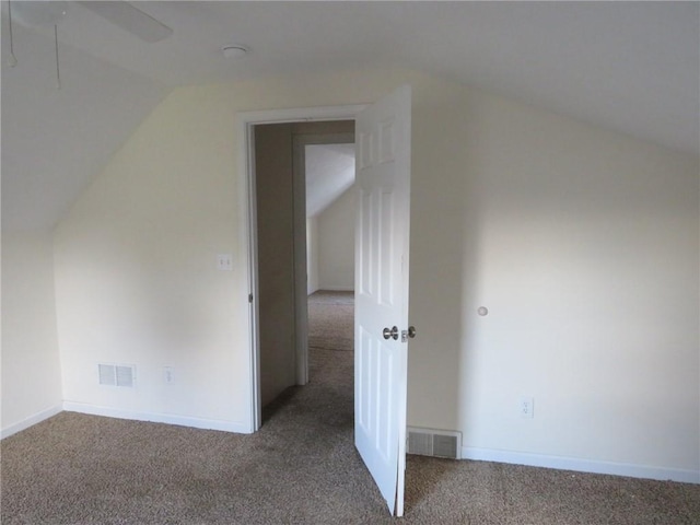 additional living space featuring lofted ceiling, carpet, visible vents, and baseboards