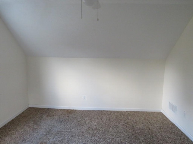 additional living space with lofted ceiling, carpet floors, visible vents, and baseboards