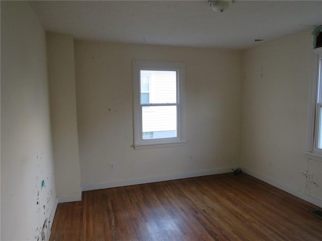 unfurnished room with wood finished floors and baseboards