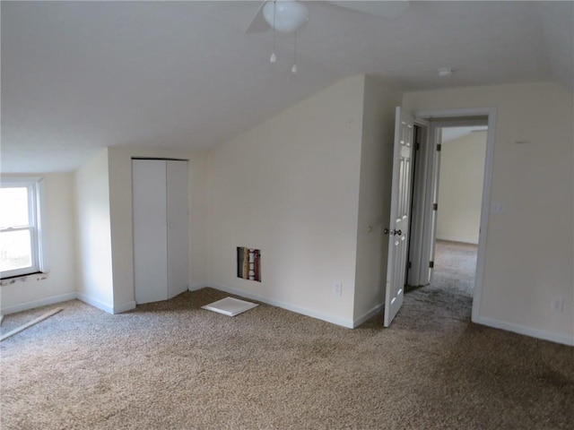 bonus room featuring carpet floors and baseboards