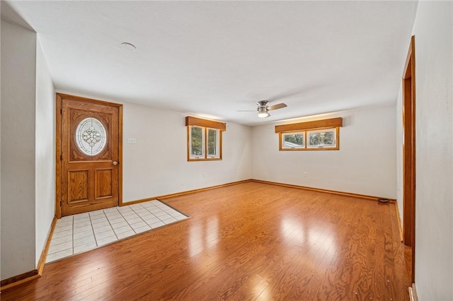 entrance foyer featuring light wood finished floors, baseboards, and a ceiling fan