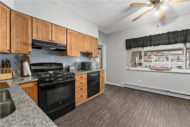 kitchen featuring under cabinet range hood, baseboard heating, decorative backsplash, black appliances, and brown cabinetry