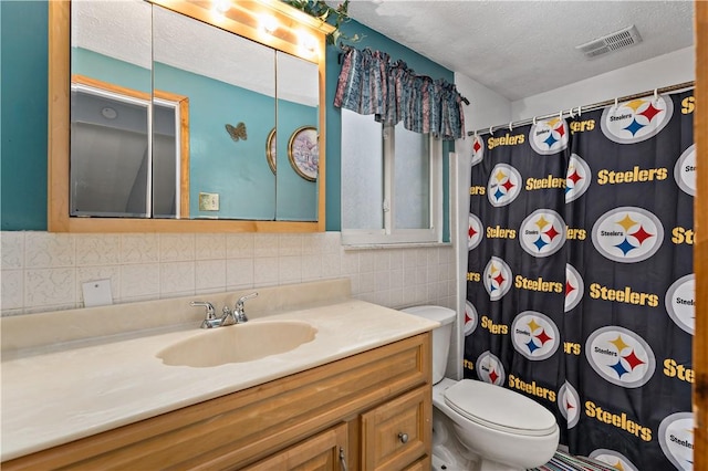 full bath with tile walls, visible vents, toilet, vanity, and a textured ceiling