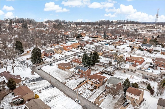 snowy aerial view with a residential view