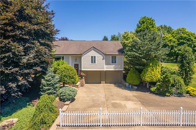 view of front of property with a garage, concrete driveway, brick siding, and fence