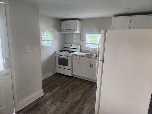 kitchen featuring white appliances, light countertops, under cabinet range hood, white cabinetry, and a sink