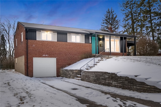 view of front of home with a garage and brick siding