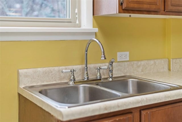 details with brown cabinets, a sink, and light countertops