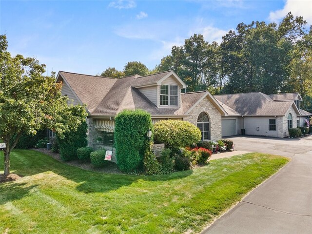1143 Links Way W, Deer, PA 15044 - view of front of house featuring concrete driveway, a front yard, an attached garage, and roof with shingles
