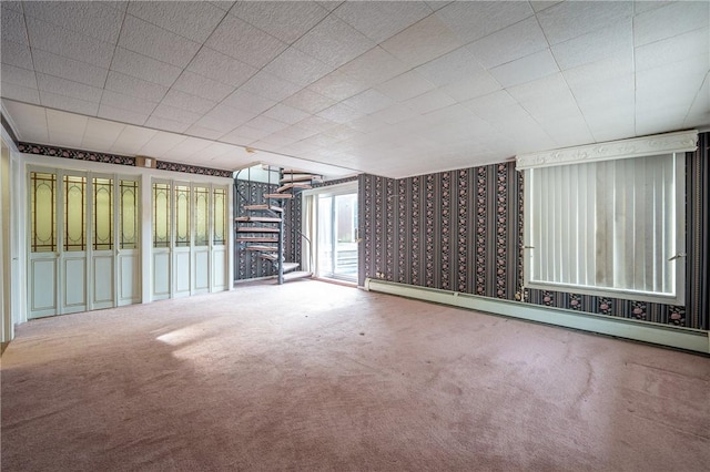 empty room with carpet floors and baseboard heating