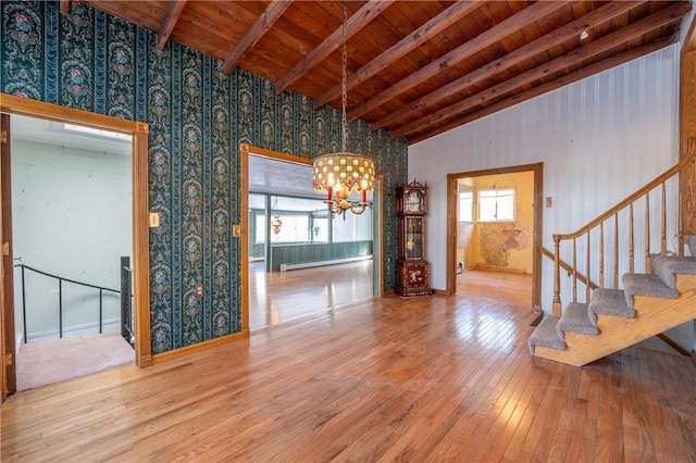 unfurnished dining area featuring a wealth of natural light, wood ceiling, wood finished floors, vaulted ceiling with beams, and a notable chandelier