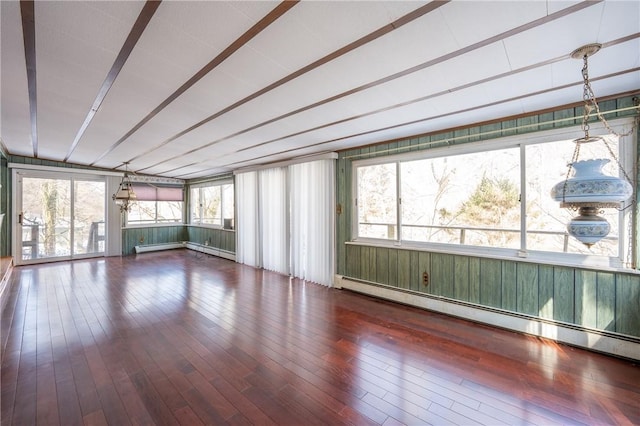 unfurnished sunroom featuring a baseboard heating unit