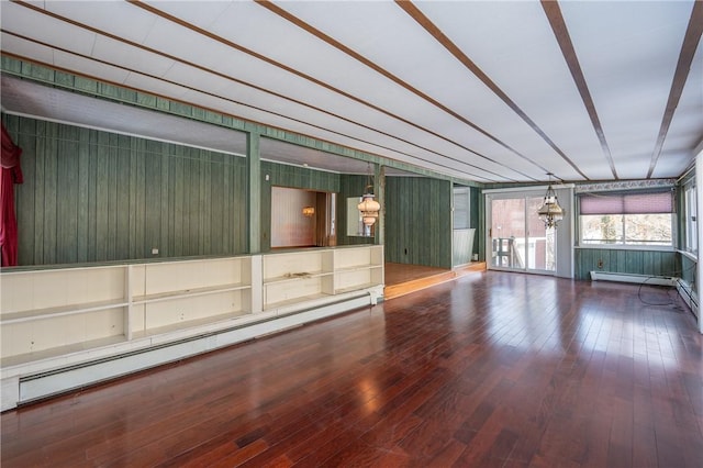 spare room featuring a baseboard radiator and hardwood / wood-style flooring