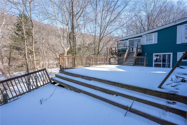 snow covered deck with stairs