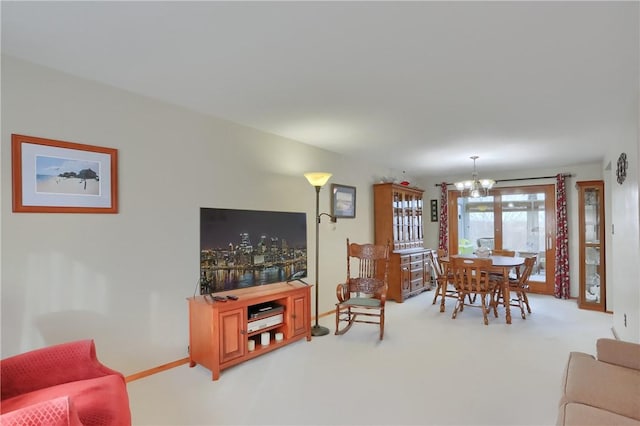 carpeted living room with a notable chandelier