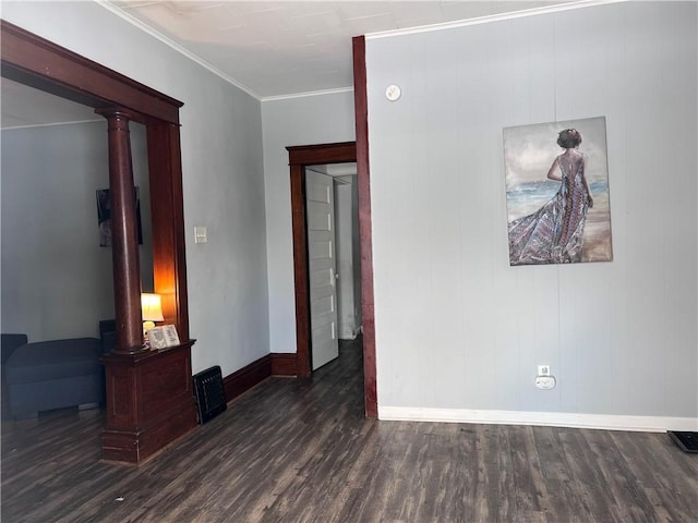 unfurnished room with crown molding, baseboards, and dark wood-style flooring