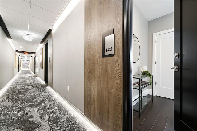 hallway with wood finished floors and baseboards